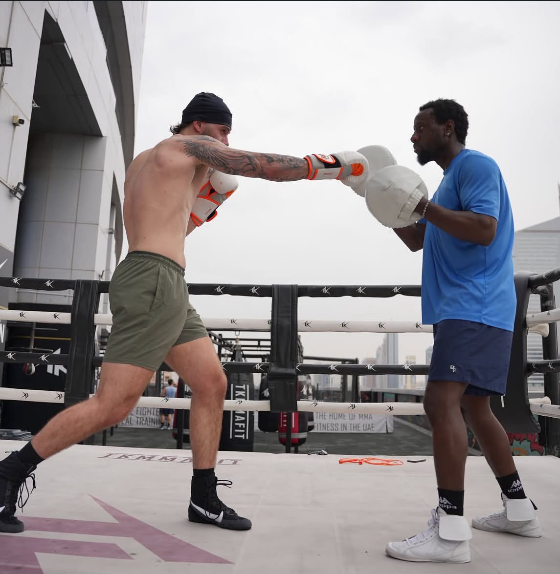 Coach Allid on the pads during an outdoor rooftop session