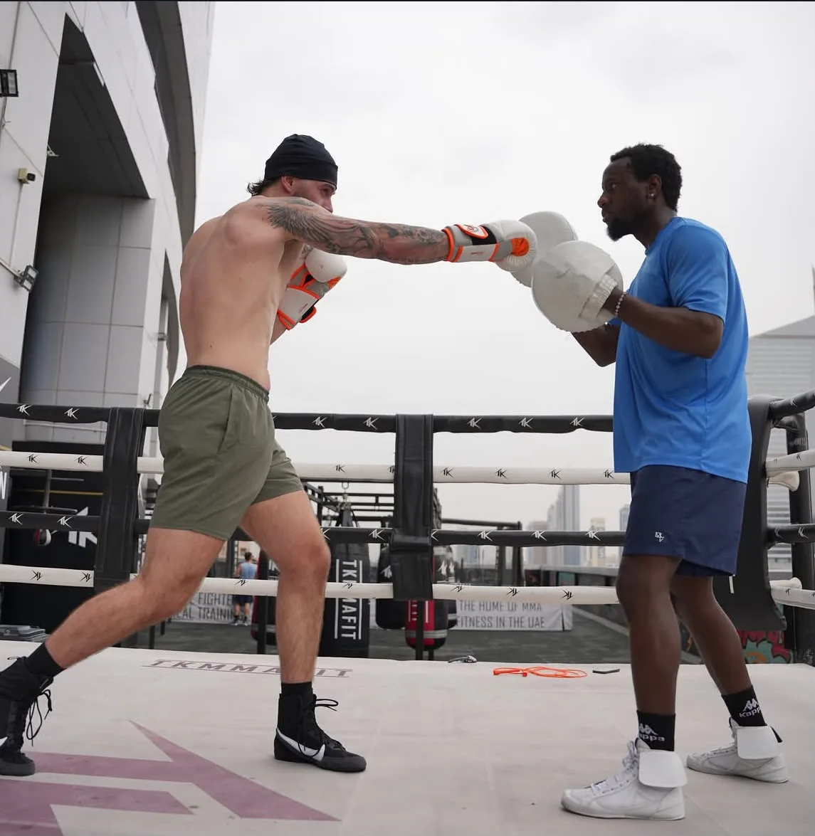 Coach Allid on the pads during an outdoor rooftop session